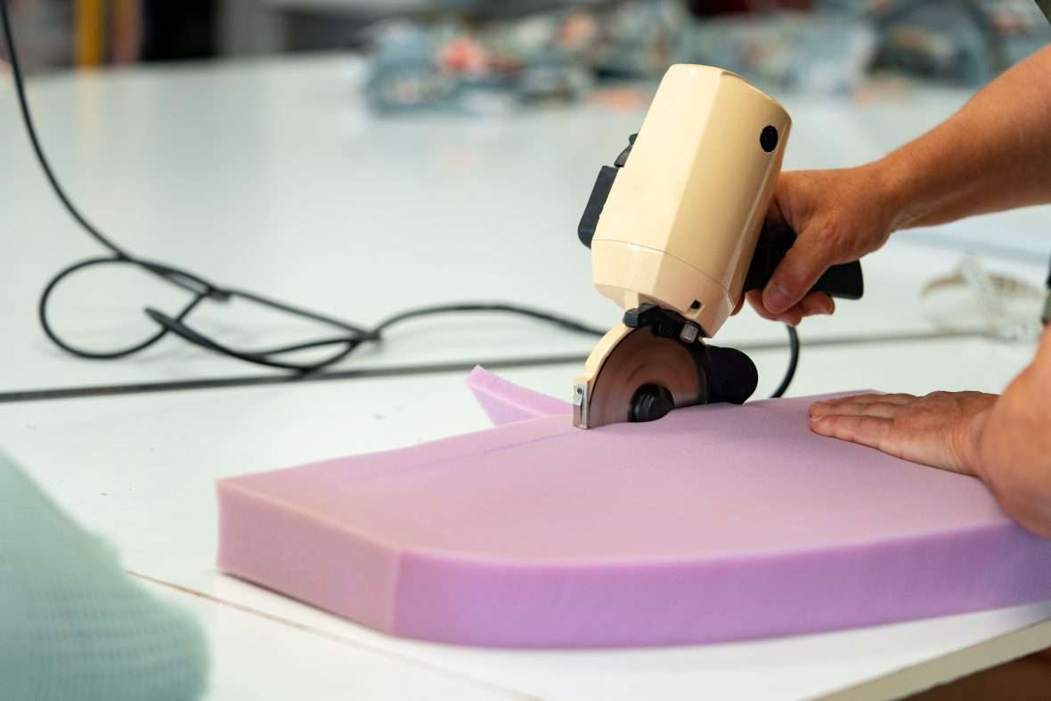 shock absorbing foam being cut for automotive use